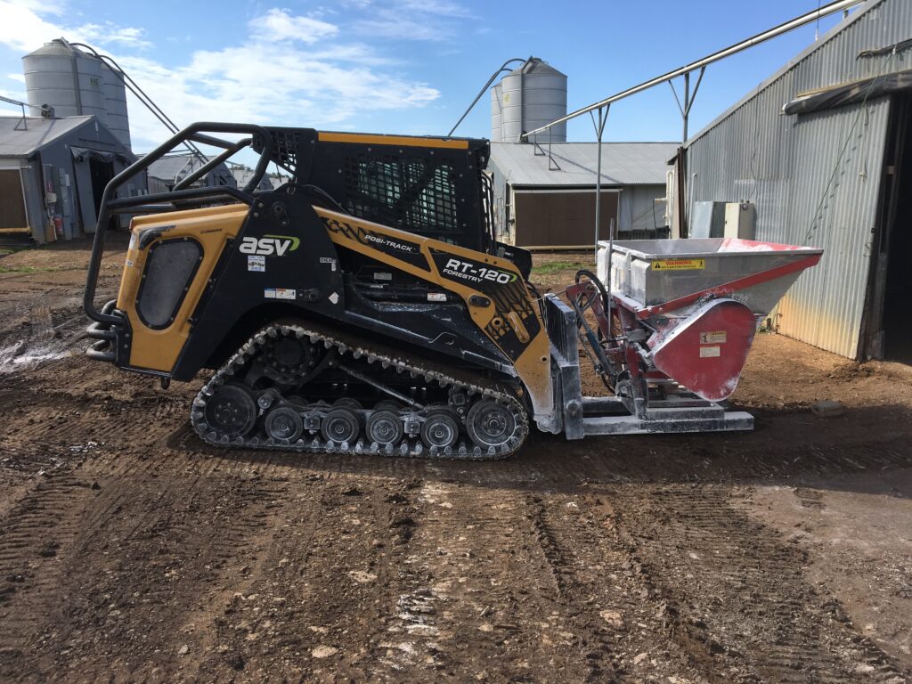 spreading lime in chicken sheds at Windsor Nsw